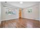 Bright living room featuring wood floors, a cozy atmosphere, and lots of natural light at 10309 108Th Ave, Largo, FL 33773
