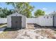View of two backyard storage sheds, with white fence providing privacy at 10309 108Th Ave, Largo, FL 33773