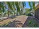 A private, tree-lined backyard features a fenced perimeter and serene green space at 10315 Riverdale Rise Dr, Riverview, FL 33578