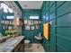 Charming powder room with decorative wall paneling, granite countertop and floral wallpaper at 10315 Riverdale Rise Dr, Riverview, FL 33578