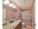 Pink bathroom with vanity sink, granite countertop, and tub shower at 10315 Riverdale Rise Dr, Riverview, FL 33578