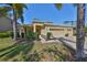 Charming home with a three-car garage, well-maintained landscaping, and mature palms at 10315 Riverdale Rise Dr, Riverview, FL 33578