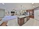 Open floor plan featuring a kitchen with a large island and stainless steel dishwasher at 10315 Riverdale Rise Dr, Riverview, FL 33578