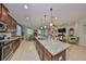 Open-concept kitchen with granite countertops and stainless steel appliances at 10315 Riverdale Rise Dr, Riverview, FL 33578