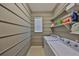 Functional laundry room with washer, dryer, shelving, and window at 10315 Riverdale Rise Dr, Riverview, FL 33578