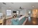 Comfortable living room with plush sofa, dark hardwood floors, and ample natural light at 10315 Riverdale Rise Dr, Riverview, FL 33578