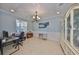 Bright home office with decorative ceiling, tile floor, and plenty of space for work at 10315 Riverdale Rise Dr, Riverview, FL 33578