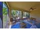 Relaxing screened patio with comfortable seating, ceiling fan, and serene views at 10315 Riverdale Rise Dr, Riverview, FL 33578