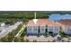 An aerial view of a charming waterfront residence with a terracotta roof and lush landscaping at 1076 Paseo Del Rio Ne, St Petersburg, FL 33702