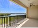 Spacious balcony overlooking the water with a ceiling fan and black metal railing at 1076 Paseo Del Rio Ne, St Petersburg, FL 33702