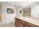 Neat bathroom featuring a single sink, toilet, and a tiled shower with glass doors at 1076 Paseo Del Rio Ne, St Petersburg, FL 33702