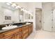 Bright bathroom featuring double sinks, granite countertops, and a glass-enclosed shower at 1076 Paseo Del Rio Ne, St Petersburg, FL 33702