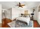 Charming bedroom with hardwood floors, a ceiling fan and a staircase at 1076 Paseo Del Rio Ne, St Petersburg, FL 33702
