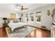 Cozy bedroom featuring hardwood floors, three windows, and decorative accents at 1076 Paseo Del Rio Ne, St Petersburg, FL 33702