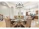 Formal dining room featuring a glass table with seating, chandelier, and tile flooring at 1076 Paseo Del Rio Ne, St Petersburg, FL 33702