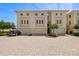 Elegant condominium exterior with private garages and manicured landscaping at 1076 Paseo Del Rio Ne, St Petersburg, FL 33702