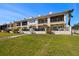 Townhome exterior with a well-maintained lawn and outdoor spaces at 1076 Paseo Del Rio Ne, St Petersburg, FL 33702