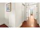Hallway with wood floors and white walls leads to other rooms with natural light at 1076 Paseo Del Rio Ne, St Petersburg, FL 33702
