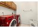 Bright laundry room featuring cherry cabinets, a modern washer and dryer, and ample storage space at 1076 Paseo Del Rio Ne, St Petersburg, FL 33702