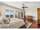 Bedroom featuring wood floors, a four-poster bed, and balcony access with a view at 1076 Paseo Del Rio Ne, St Petersburg, FL 33702