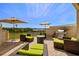 This patio features outdoor furniture, umbrellas, a grill, and scenic water views at 1076 Paseo Del Rio Ne, St Petersburg, FL 33702