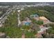 An aerial view of community amenities, including a tennis court and a basketball court, surrounded by trees at 10928 N 15Th St, Tampa, FL 33612