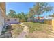 This backyard features a brick paver path, fence, patio and a single story home providing space for outdoor enjoyment at 10928 N 15Th St, Tampa, FL 33612