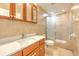 Bathroom with a vanity, mirror, toilet, and a glass enclosed shower with tile surround at 10928 N 15Th St, Tampa, FL 33612