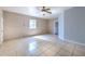 The bedroom features tile floors and a ceiling fan at 10928 N 15Th St, Tampa, FL 33612