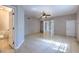 A bedroom space featuring neutral tiled floors, a ceiling fan, and an ensuite bathroom at 10928 N 15Th St, Tampa, FL 33612