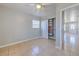 A bedroom with tile flooring, a ceiling fan, a closet, and a view to the living room at 10928 N 15Th St, Tampa, FL 33612