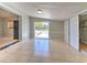 Bonus room with natural light features neutral paint, tile flooring, and an exterior door at 10928 N 15Th St, Tampa, FL 33612