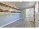 Walk-in closet boasts built-in shelving, vinyl floors, and neutral paint at 10928 N 15Th St, Tampa, FL 33612