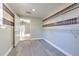 Walk-in closet boasts built-in shelving, vinyl floors, and neutral paint at 10928 N 15Th St, Tampa, FL 33612