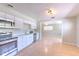Bright kitchen features stainless steel appliances, white cabinetry, and tile backsplash at 10928 N 15Th St, Tampa, FL 33612