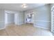 Open-concept living room with neutral walls, tile flooring, and great natural light at 10928 N 15Th St, Tampa, FL 33612