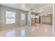 Bright living room with tile flooring, large windows, and an open view to the kitchen and dining area at 10928 N 15Th St, Tampa, FL 33612