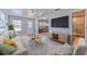 Living room featuring modern furnishings, neutral paint, and an open view to the dining and bathroom at 10928 N 15Th St, Tampa, FL 33612