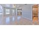 Bright living room with tile flooring, large windows, and an open view to the dining and bathroom at 10928 N 15Th St, Tampa, FL 33612