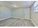 A versatile room featuring gray vinyl floors, neutral paint, and natural light at 10928 N 15Th St, Tampa, FL 33612