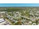 Clear aerial view of a community close to commercial areas and tree-lined streets at 11114 Freedom Way, Seminole, FL 33772