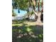 Backyard with mature trees, and a white vinyl privacy fence at 11114 Freedom Way, Seminole, FL 33772