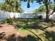 Green backyard featuring a privacy fence and mature trees offering shade at 11114 Freedom Way, Seminole, FL 33772