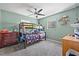 Bedroom with bunk beds, a ceiling fan, carpeting, and a view of the room's closet and dresser at 11114 Freedom Way, Seminole, FL 33772