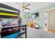 Bedroom showcasing a bunk bed, carpeting, TV on the wall, and wooden desk at 11114 Freedom Way, Seminole, FL 33772