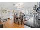 Open kitchen featuring stainless steel appliances, a dining table, and wood-look floors at 11114 Freedom Way, Seminole, FL 33772