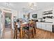 Bright kitchen featuring modern appliances, stylish backsplash, and a wooden dining table at 11114 Freedom Way, Seminole, FL 33772