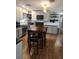 Bright kitchen with white cabinets, wood floors, and a rustic wood table with chairs at 11114 Freedom Way, Seminole, FL 33772