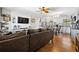 Open living room with wood floors, kitchen view, TV, and stylish decor, great for Gathering time at 11114 Freedom Way, Seminole, FL 33772