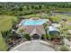 Aerial view of a community pool, playground, and surrounding trees at 11310 Callaway Pond Dr, Riverview, FL 33579